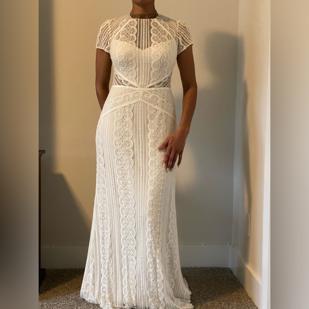 Beautiful white lace wedding dress, feminine, whimsical, and graceful.